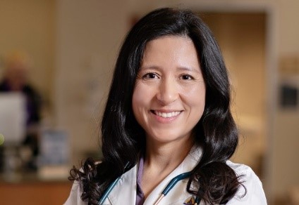 Professional headshot of Dr. Shirley Duarte, wearing a white Johns Hopkins Medicine lab coat and stethoscope, smiling in a clinical setting.